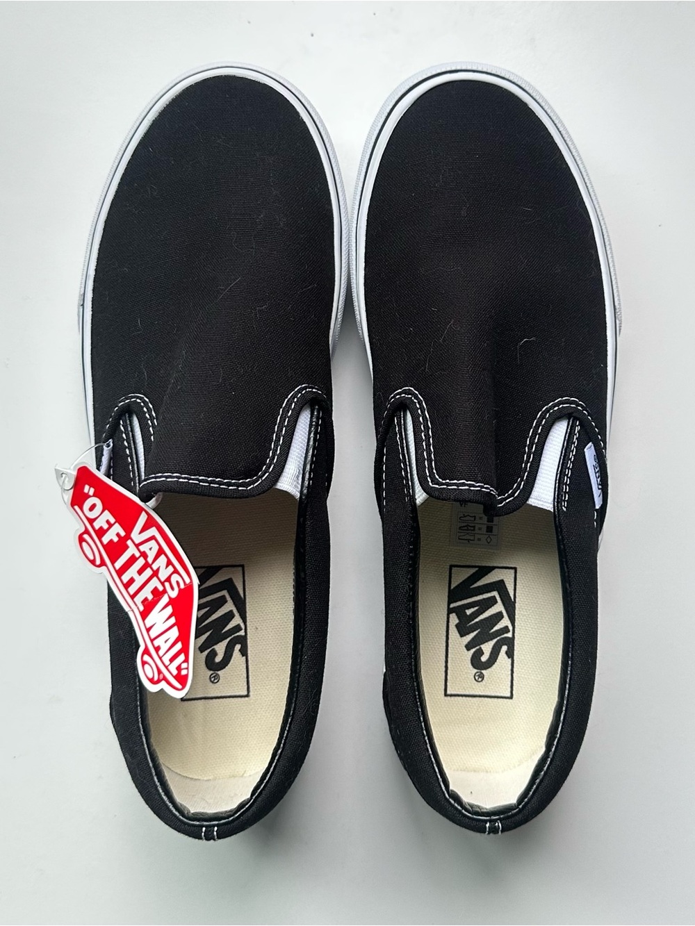 Vans Slip-On Sneakers in Black with White Trim